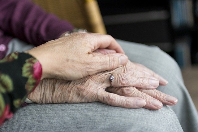 Hands on top of another person's hands