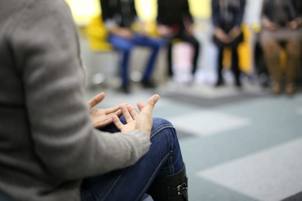Group of people in a circle in a support group setting