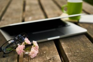 laptop with glasses and flowers